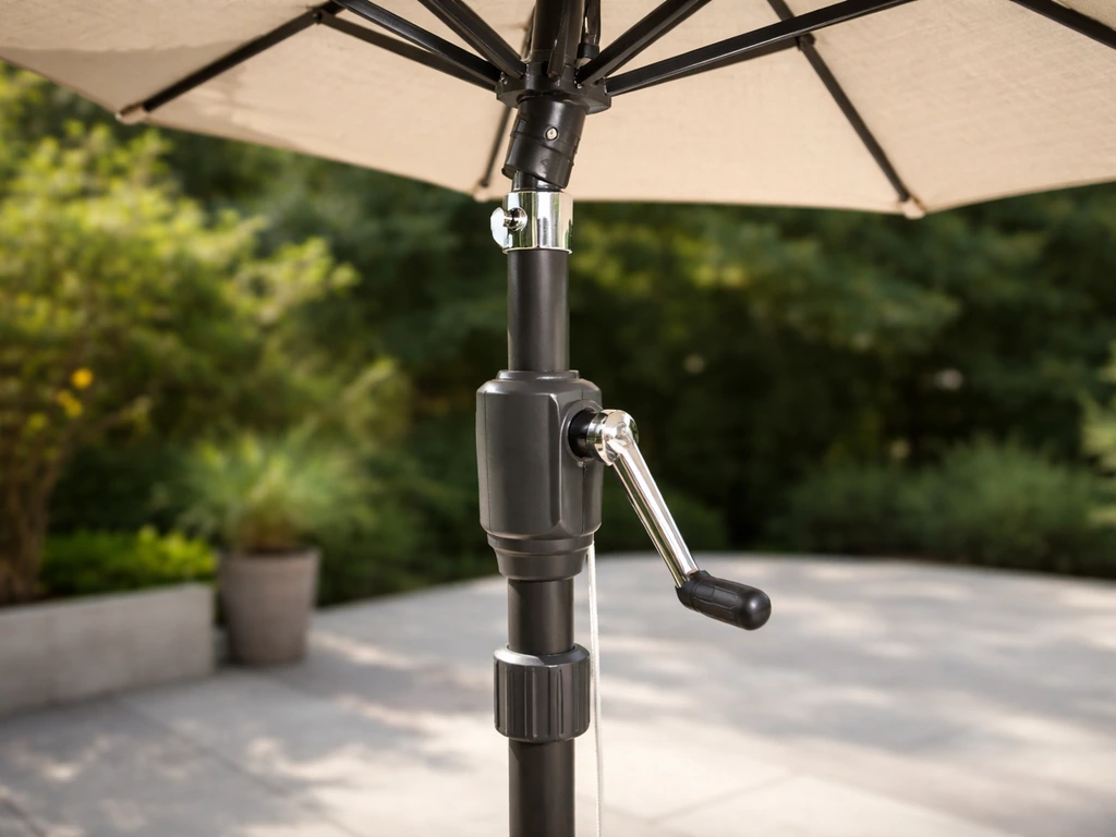 Close-up of a patio umbrella’s height collar, tilt joint, and crank mechanism in an outdoor setting.