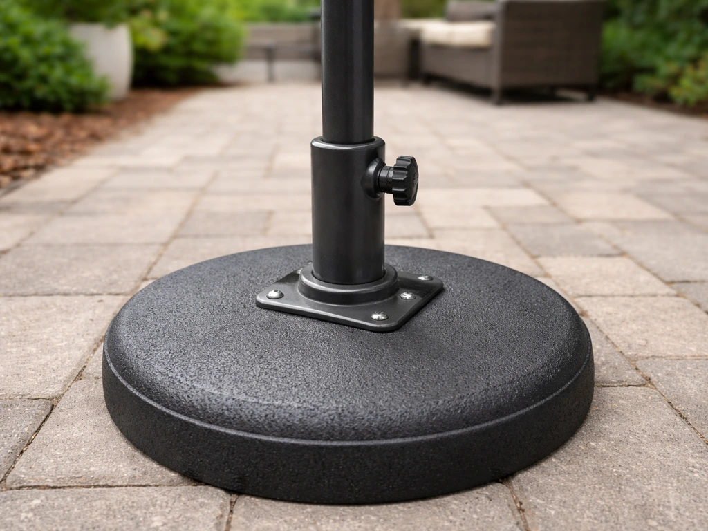 Steady patio umbrella upright, camera focused on the base-to-pole connection area outdoors.